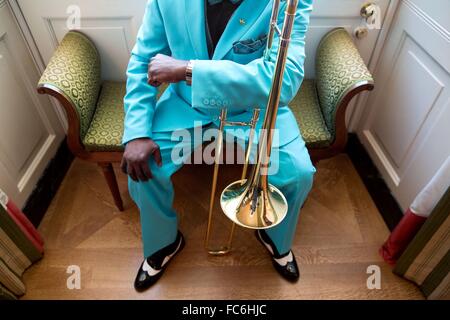 Buena Vista Social Club trombonist Jesus Aguaje Ramos waits in the Green Room of the White House prior to a reception for Hispanic Heritage Month and the 25th Anniversary of the White House Initiative on Educational Excellence for Hispanics October 15, 2015 in Washington, DC. Stock Photo