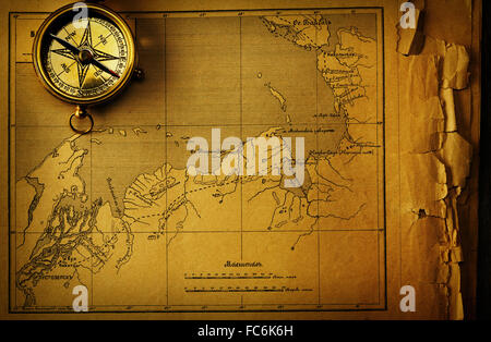 Antique compass over old map Stock Photo - Alamy