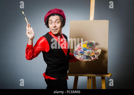 Funny artist in dark studio Stock Photo