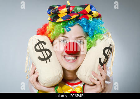 Clown with money bag in funny concept Stock Photo