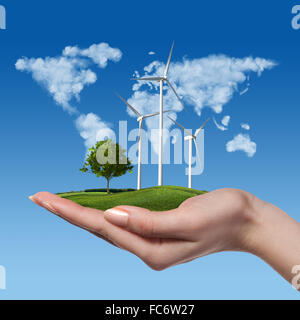 Wind turbines with tree in female hand Stock Photo