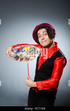 Funny artist in dark studio Stock Photo