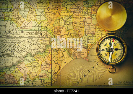 Antique compass over old XIX century map Stock Photo