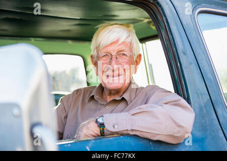 Older Caucasian man sitting in truck Stock Photo