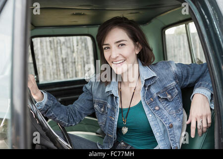 Hispanic woman sitting in truck Stock Photo
