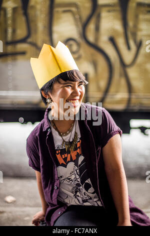 Asian woman wearing paper crown Stock Photo