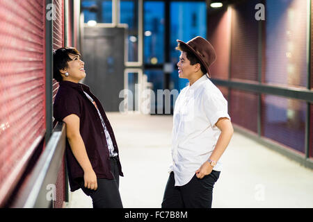 Asian couple talking in hallway Stock Photo