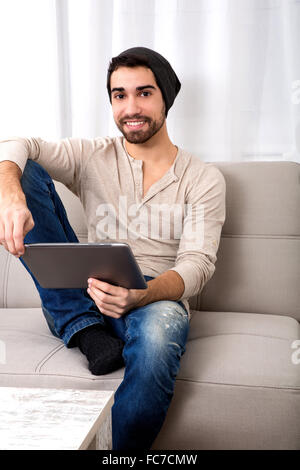 Young man using a tablet pc Stock Photo