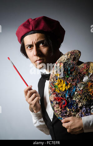Funny artist in dark studio Stock Photo