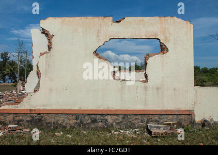 Walls of demolished house in rural field Stock Photo