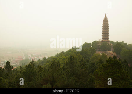 Buddhist temple tower on hilltop in remote landscape Stock Photo