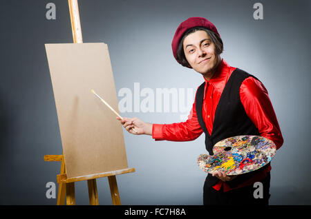 Funny artist in dark studio Stock Photo