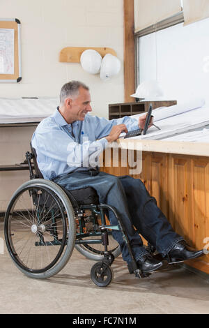 Caucasian architect using digital tablet in office Stock Photo