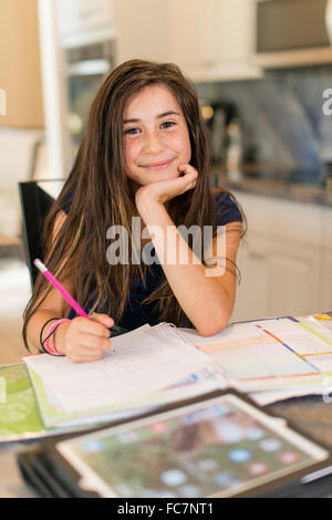 Mixed race girl doing homework Stock Photo