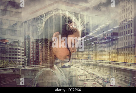 Double exposure of mixed race girl and busy cityscape Stock Photo