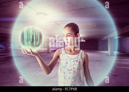 Mixed race girl holding sphere Stock Photo