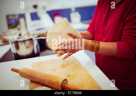 Mixed race woman cooking in kitchen Stock Photo