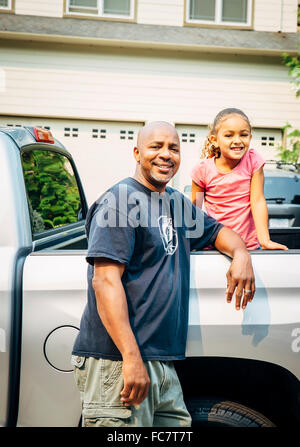 Father and daughter smiling in truck Stock Photo
