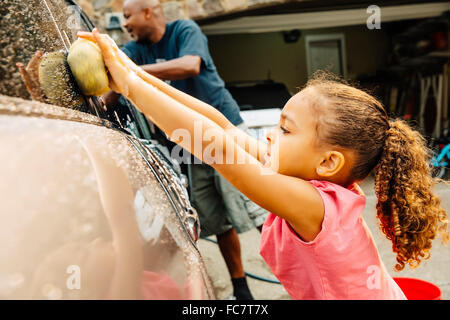 Father and daughter washing car Stock Photo