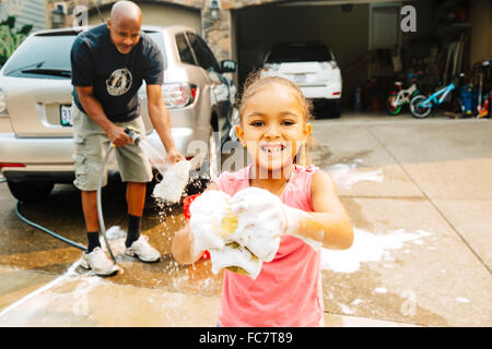 Father and daughter washing car Stock Photo