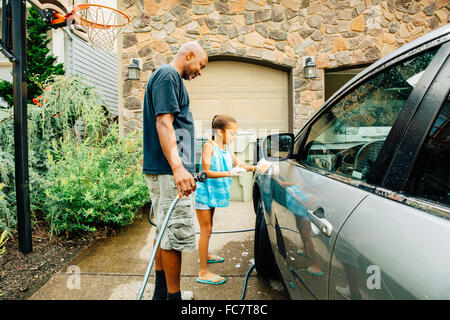 Father and daughter washing car Stock Photo