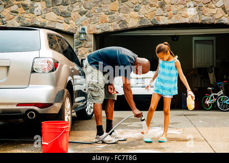 Father and daughter washing car Stock Photo