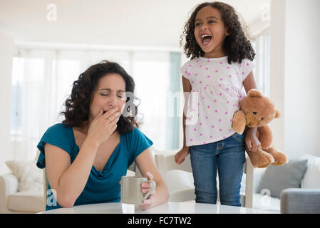 Girl shouting at stressed mother Stock Photo