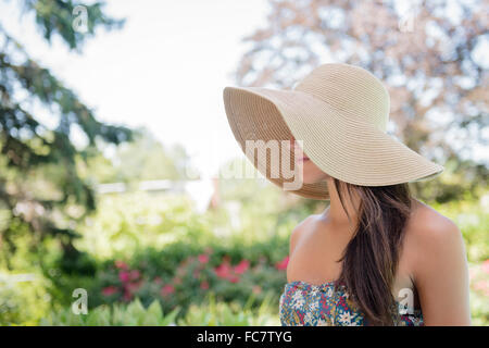 Caucasian woman wearing sun hat outdoors Stock Photo