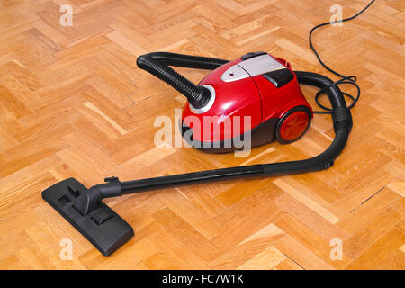 Vacuum cleaner on parquet Stock Photo