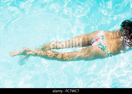 Caucasian woman swimming in pool Stock Photo