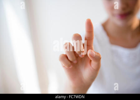 Close up of Hispanic woman pointing Stock Photo