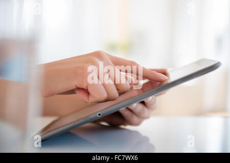 Hispanic woman using digital tablet Stock Photo