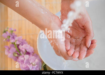 Hispanic woman washing hands Stock Photo