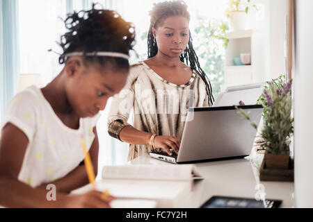 Black mother and daughter studying Stock Photo