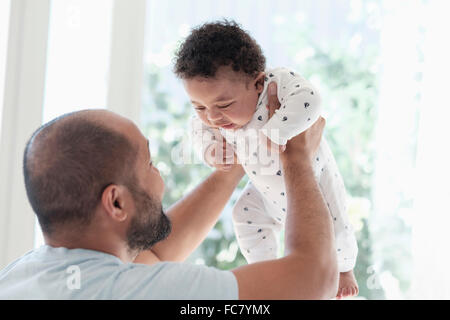Father playing with baby son Stock Photo