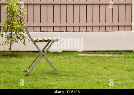 Old chair on green grass Stock Photo