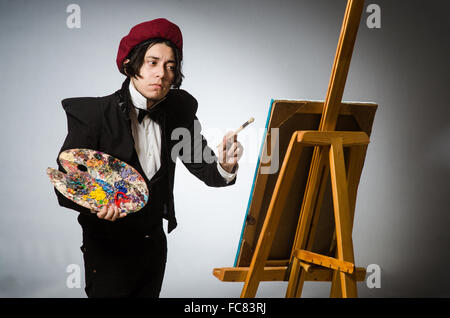 Funny artist in dark studio Stock Photo