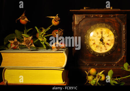 still life with old books, rose and clock Stock Photo - Alamy