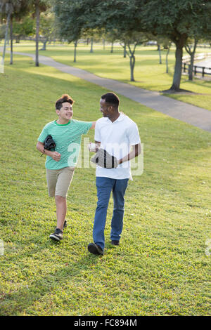 Father and son playing catch in park Stock Photo