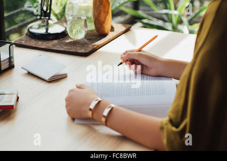 Caucasian woman studying at desk Stock Photo