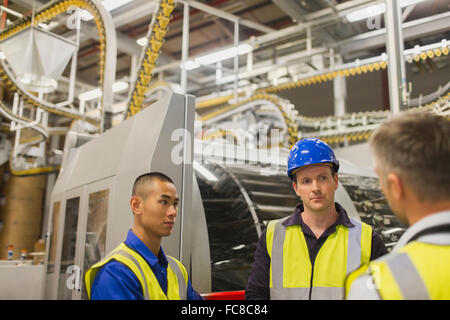 Workers talking in printing plant Stock Photo