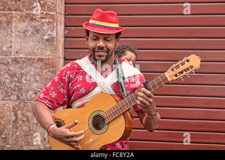 Street musician and his family playing music in Quito, Ecuador. Stock Photo