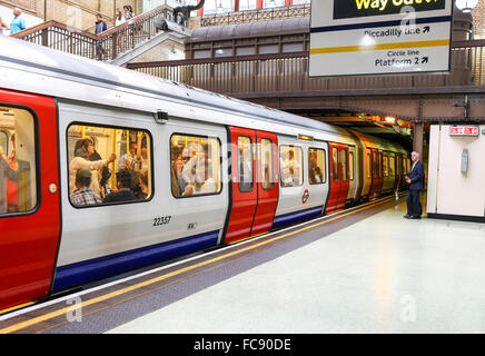 A packed commuter London Underground tube train at the platform at Gloucester Road Station Stock Photo