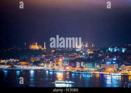 Blue Mosque and Hagia Sophia (Aya Sofya) at night seen from The Galata Tower across the Bosphorus Strait, Istanbul, Turkey Stock Photo