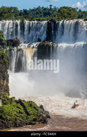 A river boat at the base of the falls, Iguazu Falls National Park, UNESCO World Heritage Site, Misiones, Argentina Stock Photo