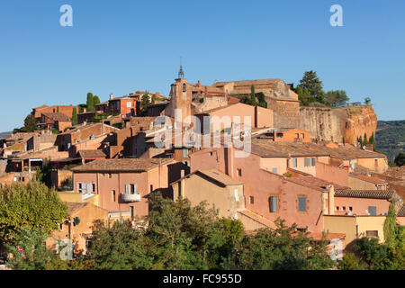 Sunrise over hilltop village of Roussillon, rocks of ochre, Provence, Provence-Alpes-Cote d'Azur, Southern France, France Stock Photo