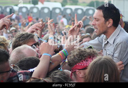 Rick Witter from Shed Seven gets close to the audience after jumping into the stage pit at the Y Not music festival Derbyshire 2 Stock Photo