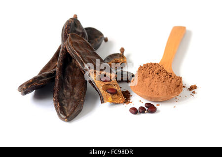 Ripe carob pods and carob powder, can be used as a substitute for cocoa Stock Photo