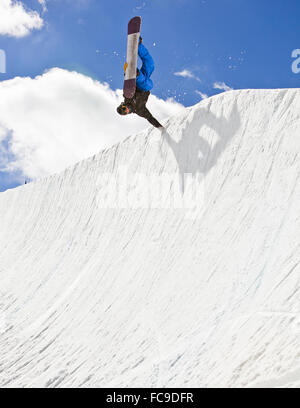 Snowboarder Riding Halfpipe Stock Photo