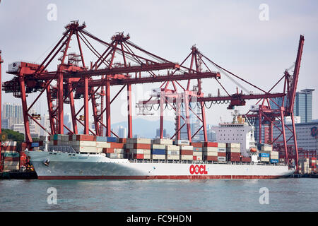 A section of Tsing Yi container terminal with a container ship being loaded or unloaded. Stock Photo